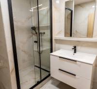 Bathroom in a 3-room apartment with a modern shower and sink.