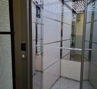 Elevator with modern design and mirrored panels, buttons and display.