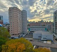 A view of buildings and the sky in Bratislava – Ružinov with autumn trees.