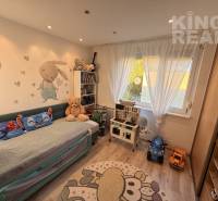 Children's room with a pull-out bed, toys, and shelves in a 3-room apartment.