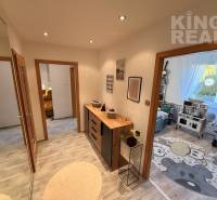 In the 3-room apartment, we see a hallway with decorative furniture and a children's room.