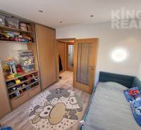 Children's room in a 3-room apartment with toys, storage spaces, and a floor with a wooden decor.