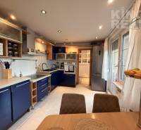 A kitchen in a 3-room apartment with blue cabinets and white walls.