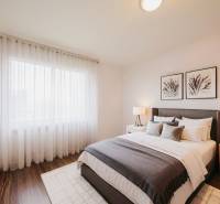 Bedroom in a 3-room apartment with a bed, nightstands, and a floor with a wooden decor.