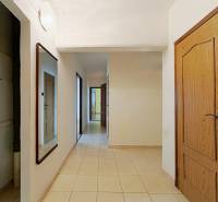 Tiled floor, wooden door, and mirror in a 3-room apartment.