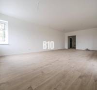 A room with laminate flooring and light walls, ideal for a 3-room apartment.