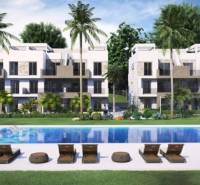 A holiday apartment in Guardamar del Segura with a pool, sun loungers, and palm trees.