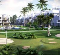 A holiday apartment in Guardamar del Segura with a view of the golf course surrounded by palm trees.