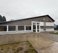 Commercial premises on Dolné Chlebany Street in Dolné Chlebany, with large windows and a paved area.