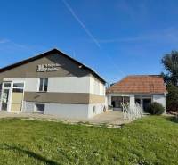 Commercial premises in Dolné Chlebany with a green lawn and a sloped roof.
