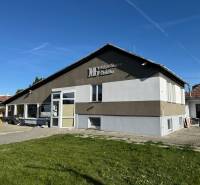 The commercial spaces in Dolné Chlebany stand out with large windows and a modern facade.