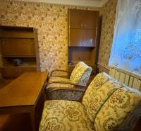 Interior of a family house with antique furniture and decorative wallpaper on the wall.