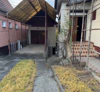 A family house in the center of Veľké Lovce with a shelter, stairs, and a garden path.