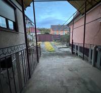 A family house in the center of Veľké Lovce with a view of the paved courtyard and garden.