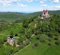 The Calvary in Banská Štiavnica, surrounded by greenery and wooded hills, offers a magnificent view.