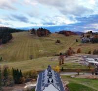 Ski slopes and forests in Donovaly with mountain buildings in the background.