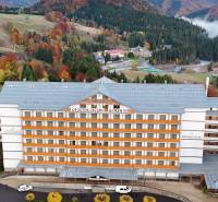 An aerial view of a hotel surrounded by autumn landscape in Donovaly.