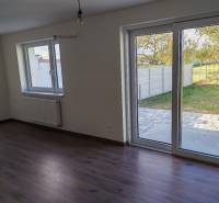 Interior of a 3-room apartment with large windows and a floor with a wooden decor.