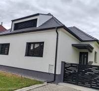 A family house in Jaslovské Bohunice with a white facade and a black roof.