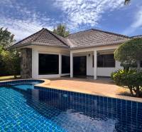 A villa in Pattaya with a pool, surrounded by greenery and a peaceful atmosphere for relaxation.