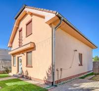 A family house in Cífer on Cífer Street with a lawn and a fence in the yard.