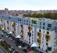 Apartment building on Rusovská Road in Bratislava - Petržalka, with parking and greenery.