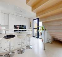 A kitchen with a stylish bar counter and a wooden decor floor in a 4-room apartment.