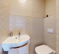 A bathroom with a stylish sink and ceramic tiles in a 4-room apartment.