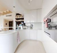 Kitchen in a 4-room apartment with white cabinets and a wood-patterned floor.