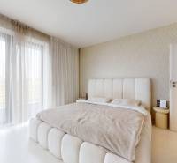 Bright bedroom with a sofa bed and curtains in a 4-room apartment.