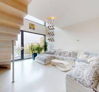 A spacious living area with a comfortable sofa and a unique staircase in a 4-room apartment.