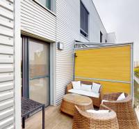 The balcony of a 4-room apartment on Rusovská cesta in Bratislava - Petržalka with a view of the city.