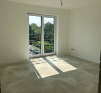 Empty room in a family house with glass doors and a concrete floor.