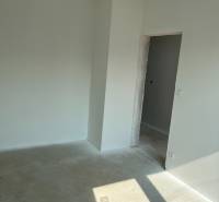 Empty room with white walls and ceiling, concrete floor, preparation in a family house.