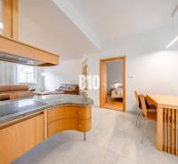 Interior of a 3-room apartment with an open living room, dining table, and cooking area.