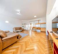 Living room in a 3-room apartment with leather sofas and a floor with a wooden decor.