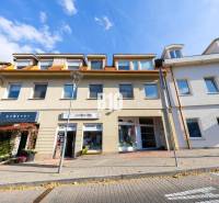 The building on Zámocká Street in Bratislava - Old Town, with commercial establishments on the ground floor.