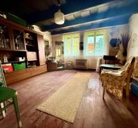 Living room in a family house with a wooden decor floor and antique furniture.