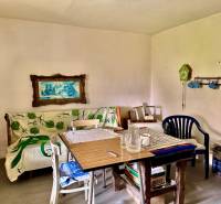 A dining room in a family house with colorful decorations and a painting on the wall.