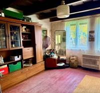 A room in a family house with old furniture and a wooden decor floor.