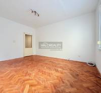 A bright room with a wood-patterned floor in a 2-room apartment.