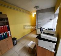 Office space with shelves, binders, yellow walls, and a printer.