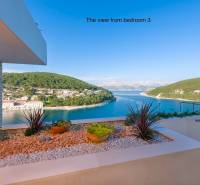 View from the villa in the town of Bol to the sea, greenery, and planted plants.