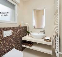 Bathroom in the villa with a stylish sink and decorative tiles.