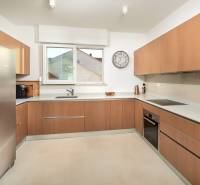 A kitchen in a villa with a wooden decor floor and modern appliances.