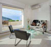 Interior of the villa, bright living room with a view of the terrace and wooden decor flooring.