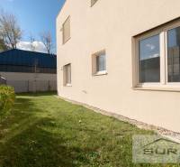 The exterior of a new 2-room apartment on Železničná Street in Bratislava - Vrakuňa, with a landscaped garden.