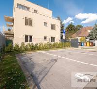 Parking lot near a two-story building on Železničná Street in Bratislava, Vrakuňa.