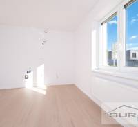 Empty room with a large window and wood-patterned floor, 2-room apartment.