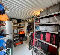A neatly organized workshop with various storage boxes and tools in the cottage.